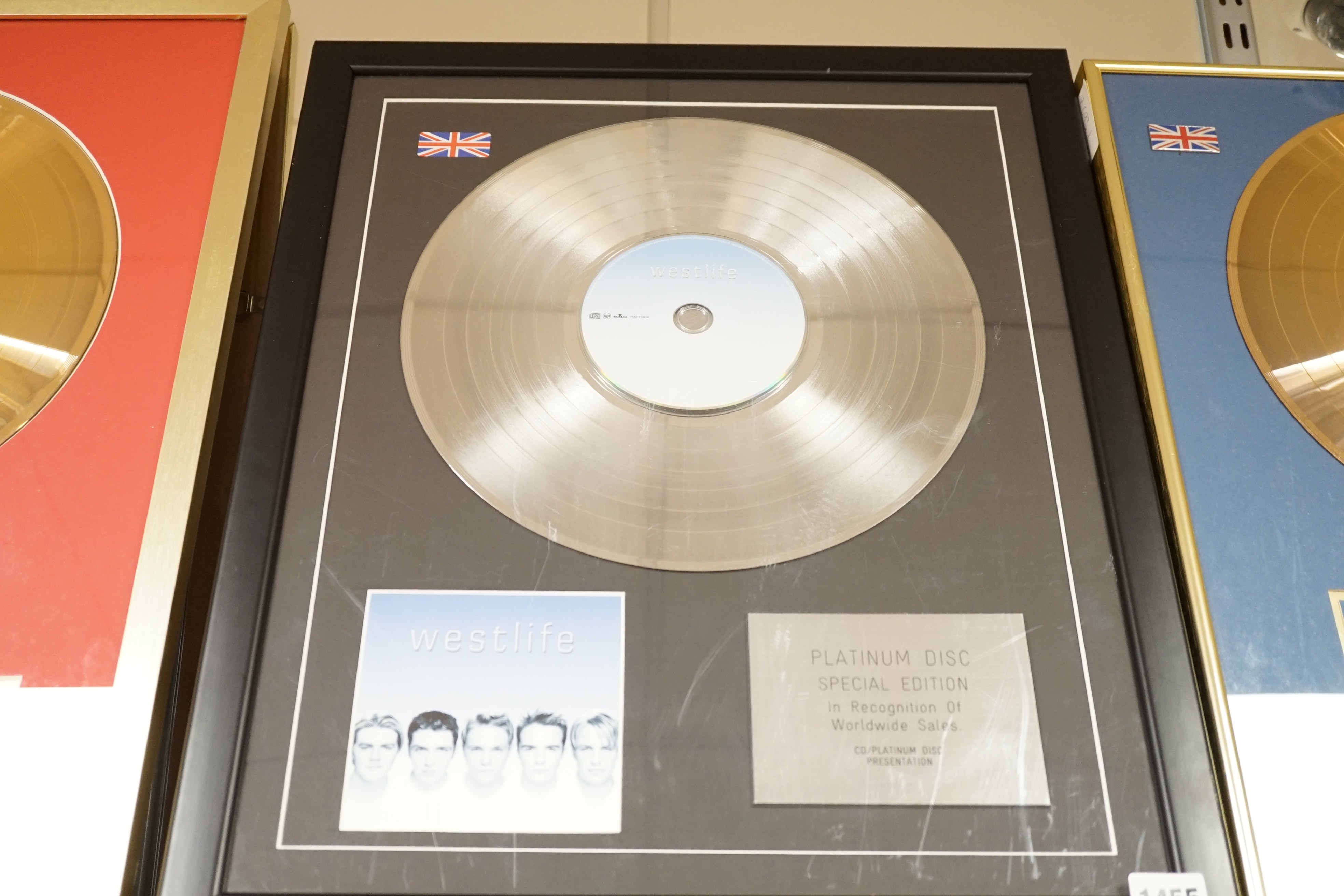 Three glazed framed award winning records: Pink Floyd, The Rolling Stones and Westlife